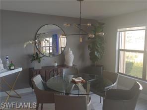 Dining area with a chandelier and baseboards