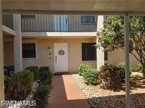 Property entrance with stucco siding