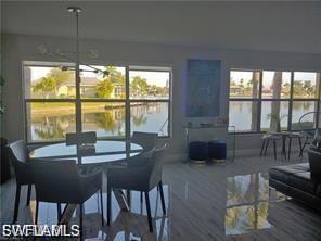 Dining area featuring a chandelier and a water view