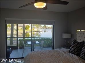 Bedroom with a water view and a ceiling fan