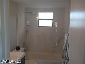 Bathroom featuring shower / washtub combination and vanity