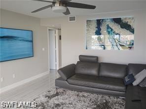 Living room with a ceiling fan and wood finished floors