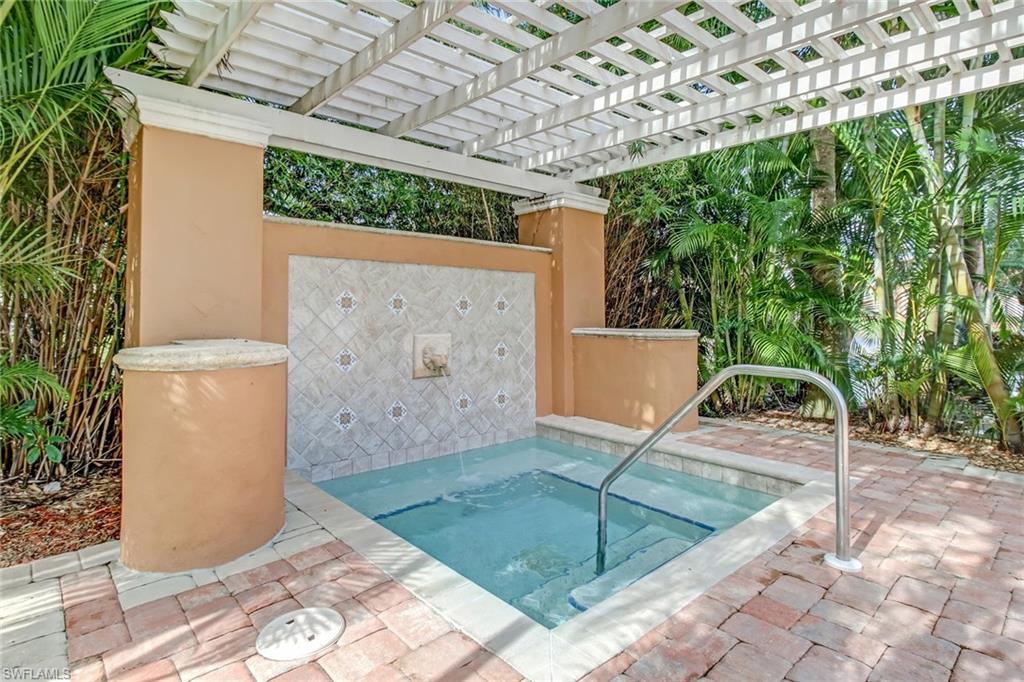 View of pool featuring a patio area, a pergola, and a community hot tub