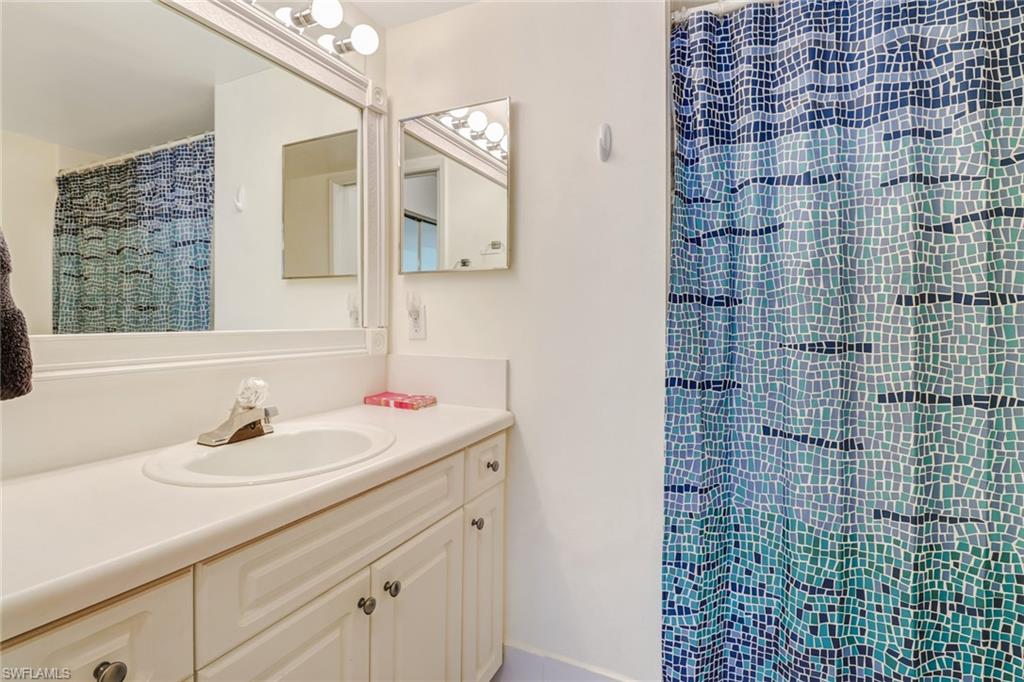 Bathroom featuring vanity and a stall shower