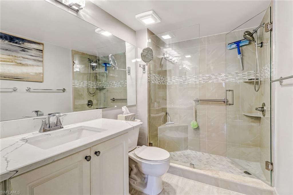 Full bath with vanity and a shower stall