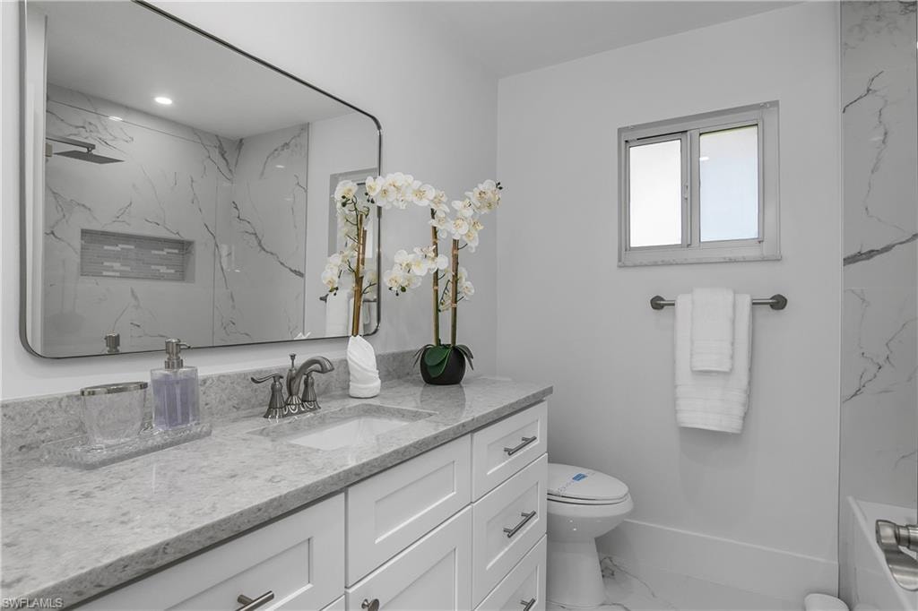 Bathroom with vanity and marble finish floors