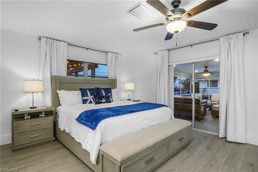 Bedroom featuring wood tiled floors and ceiling fan