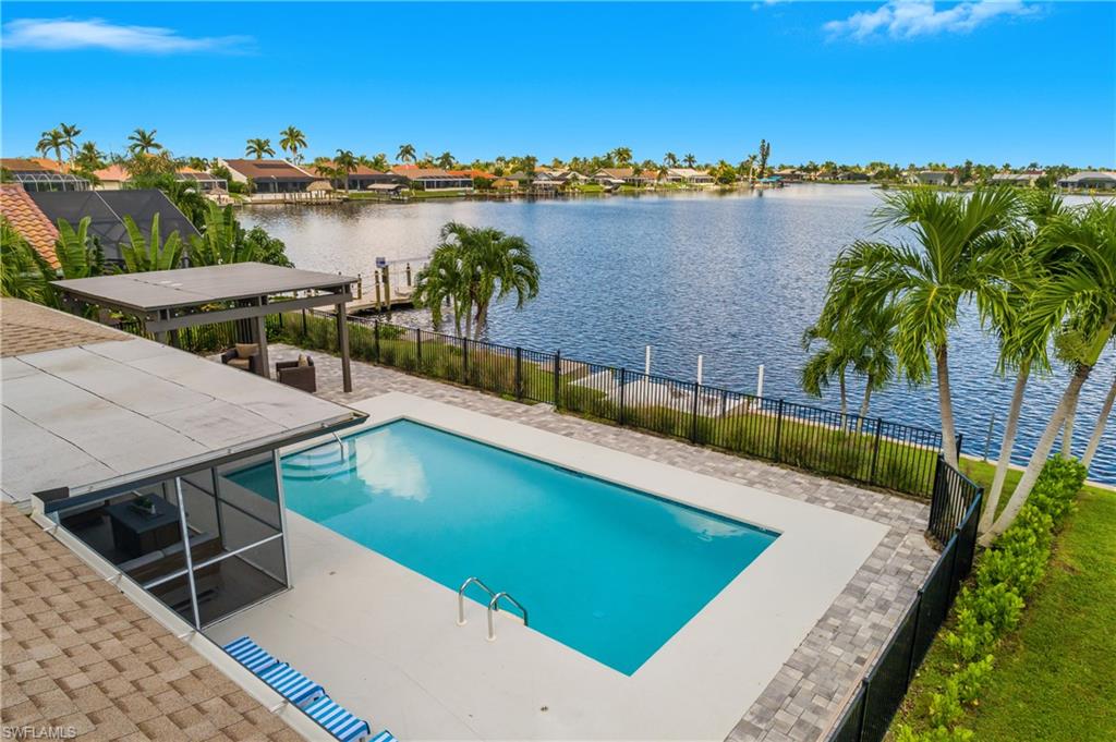 View of swimming pool featuring a patio area, a water view, and a residential view