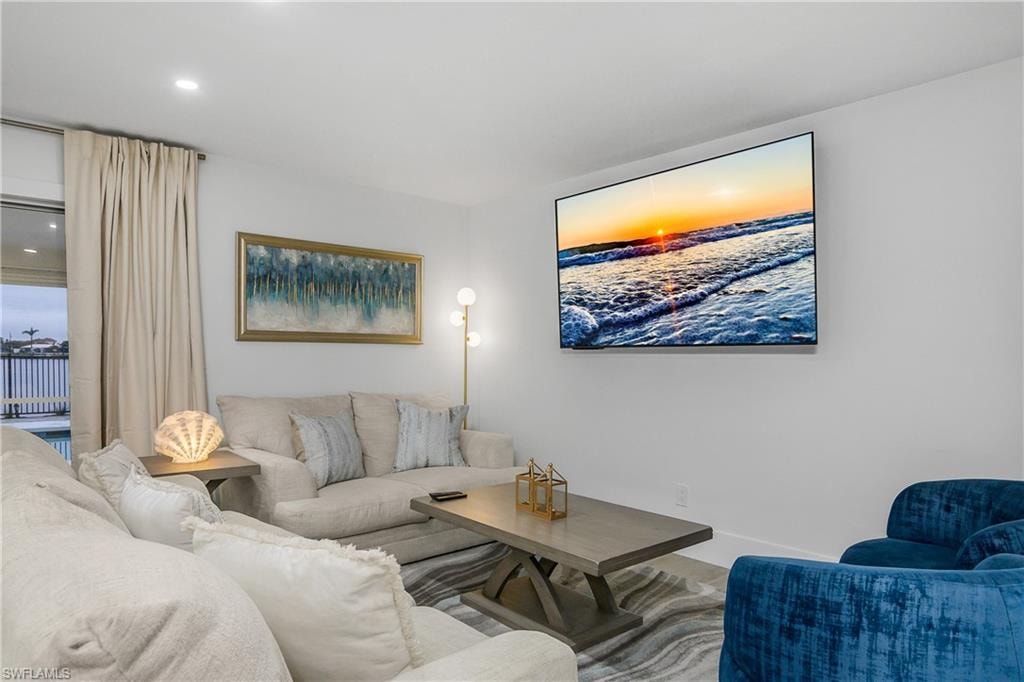 Living area featuring baseboards and recessed lighting