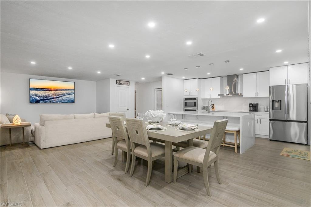 Dining room featuring light wood-style floors and recessed lighting