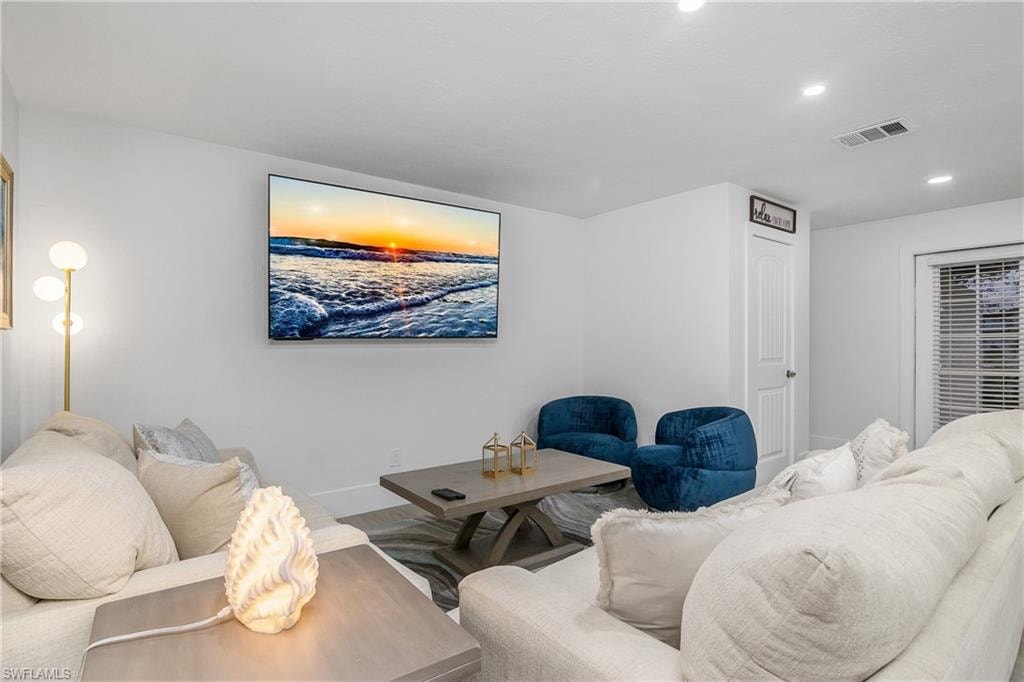 Living area with recessed lighting and baseboards