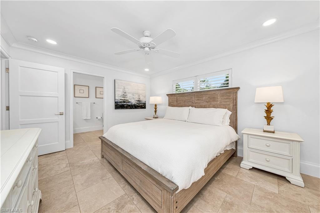 Laundry area with cabinet space, washing machine and dryer, and light tile patterned floors