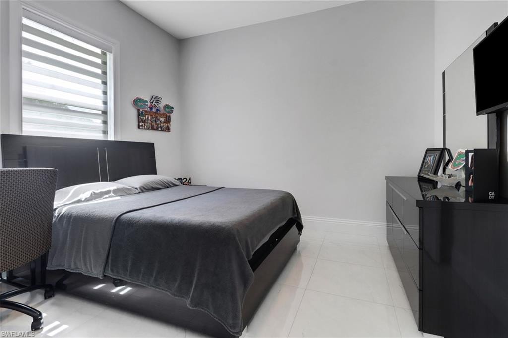 Bedroom with light tile patterned flooring