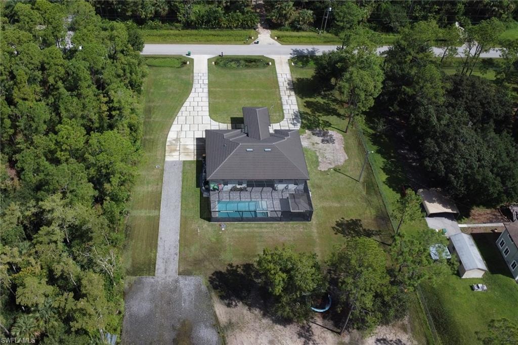 Aerial view of property and surrounding area featuring a pool area