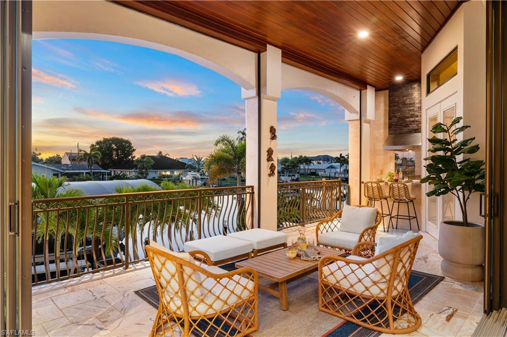 Balcony at dusk with a patio and an outdoor living space