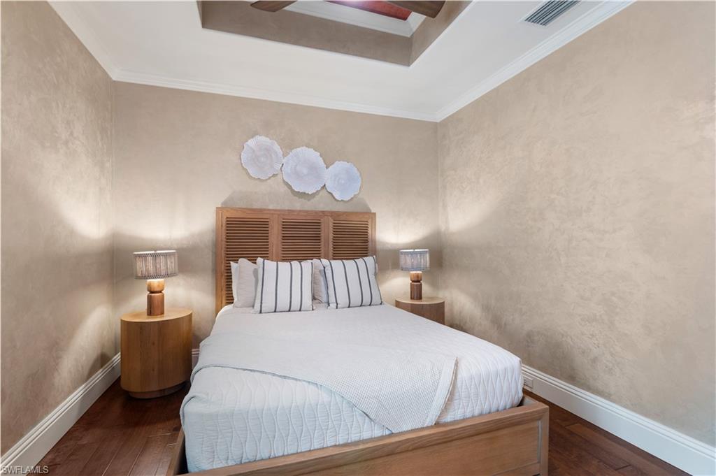 Bedroom featuring ornamental molding and dark wood-style floors