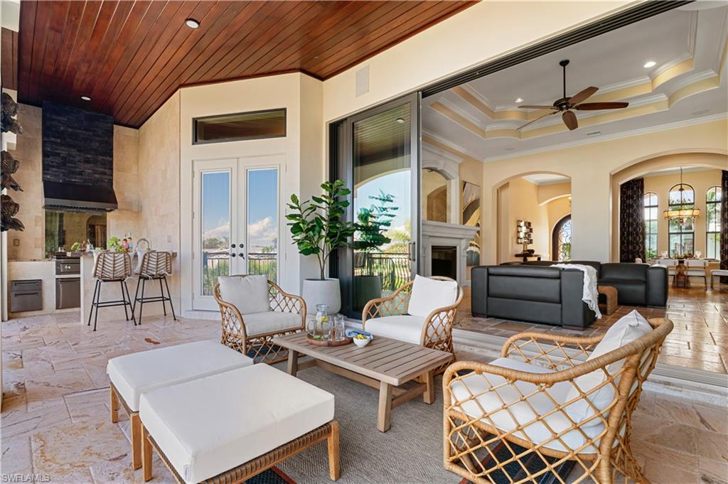 View of patio with an outdoor hangout area, french doors, ceiling fan, and an outdoor kitchen
