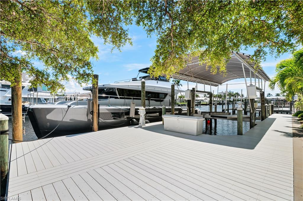 Dock area featuring boat lift and a water view