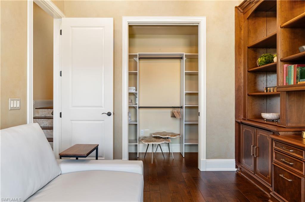 Bedroom featuring dark wood finished floors and a closet