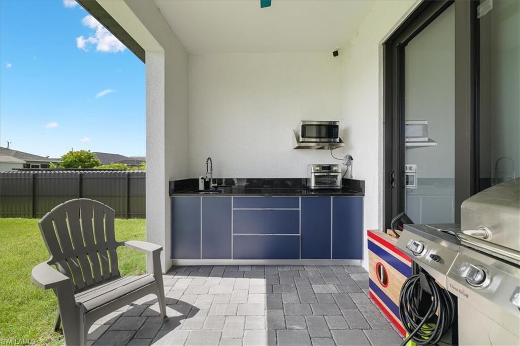 View of patio / terrace with exterior kitchen and a sink