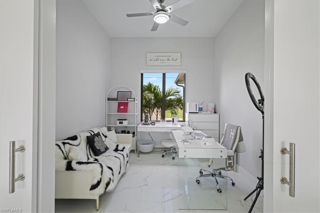 Office space with marble look tile flooring and ceiling fan