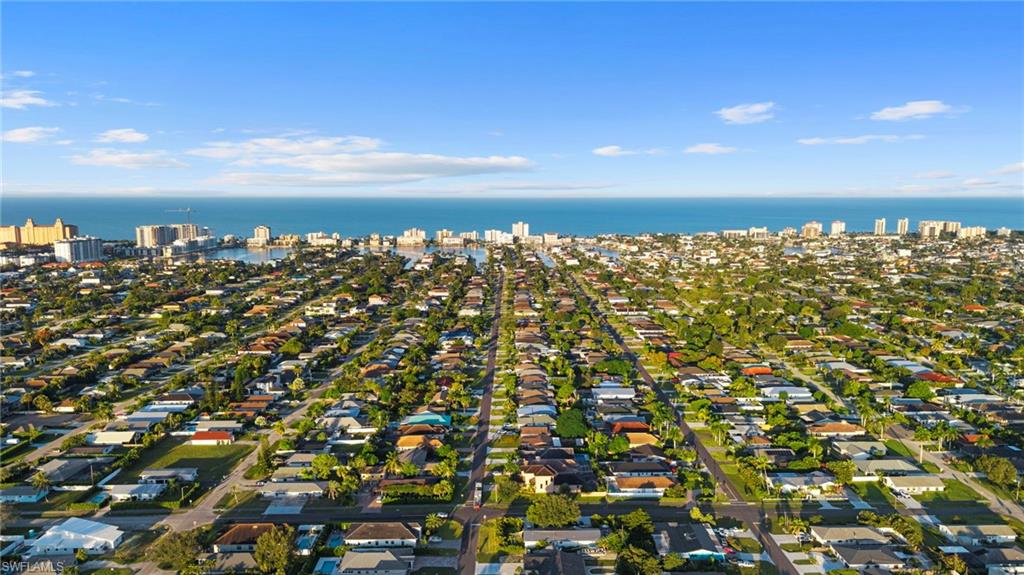 Aerial view of property's location with a large body of water