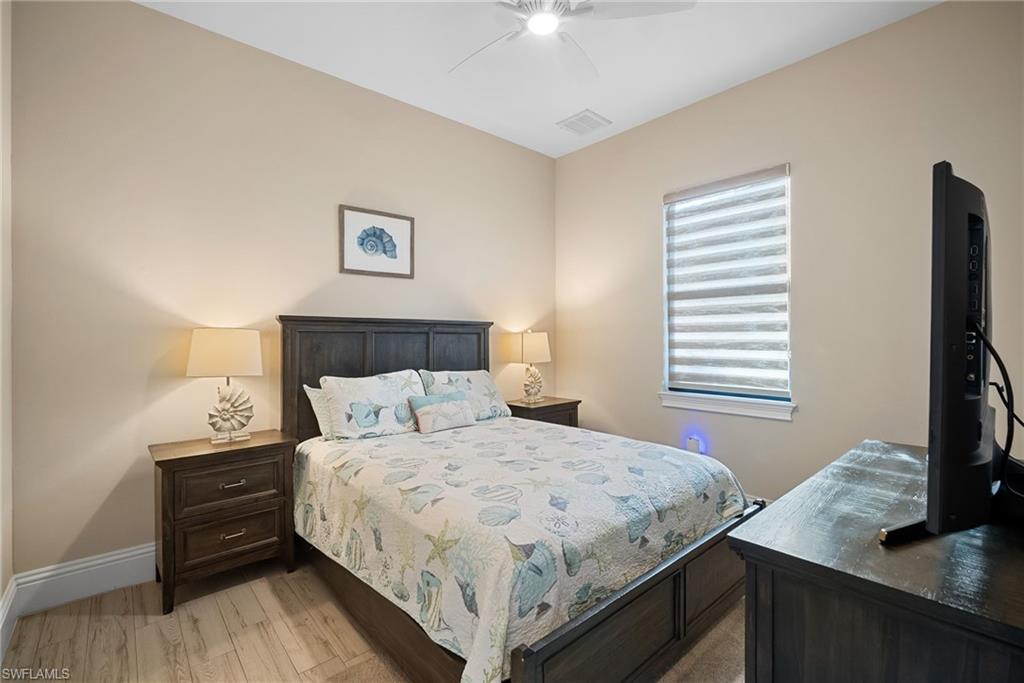 Bedroom with light wood finished floors and ceiling fan