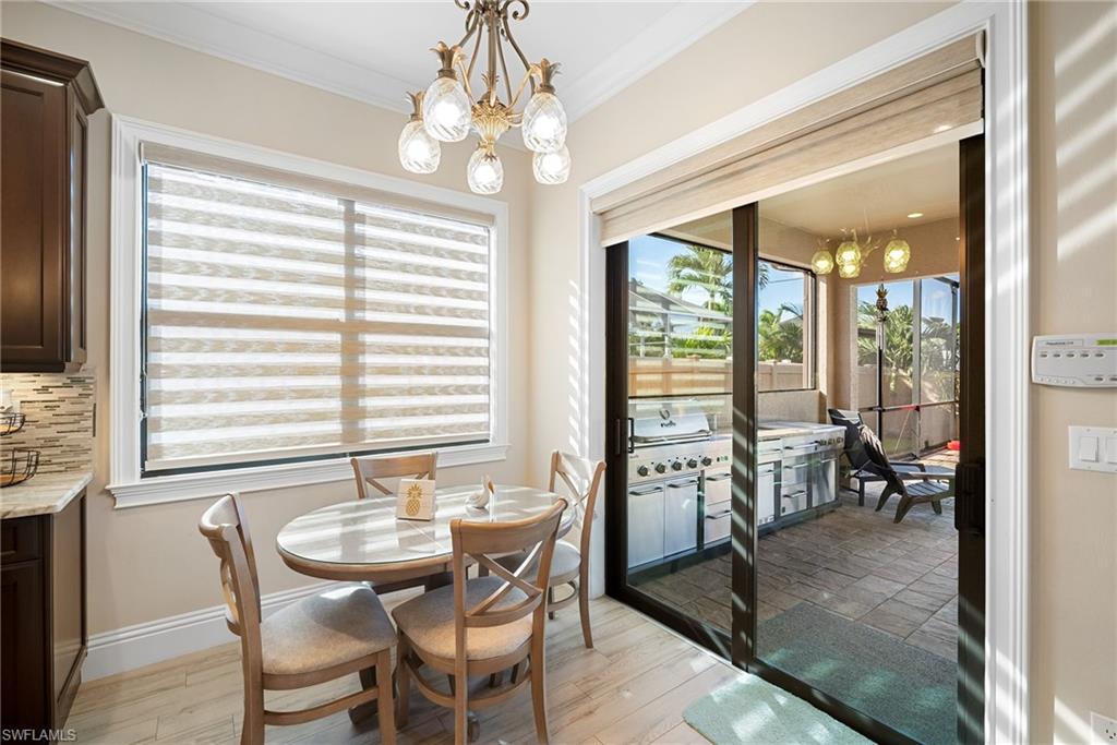 Dining area featuring a chandelier, light wood-style floors, and crown molding