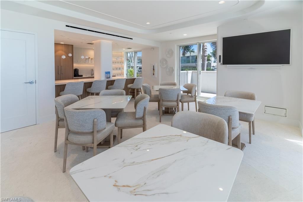 Dining area with recessed lighting and a raised ceiling