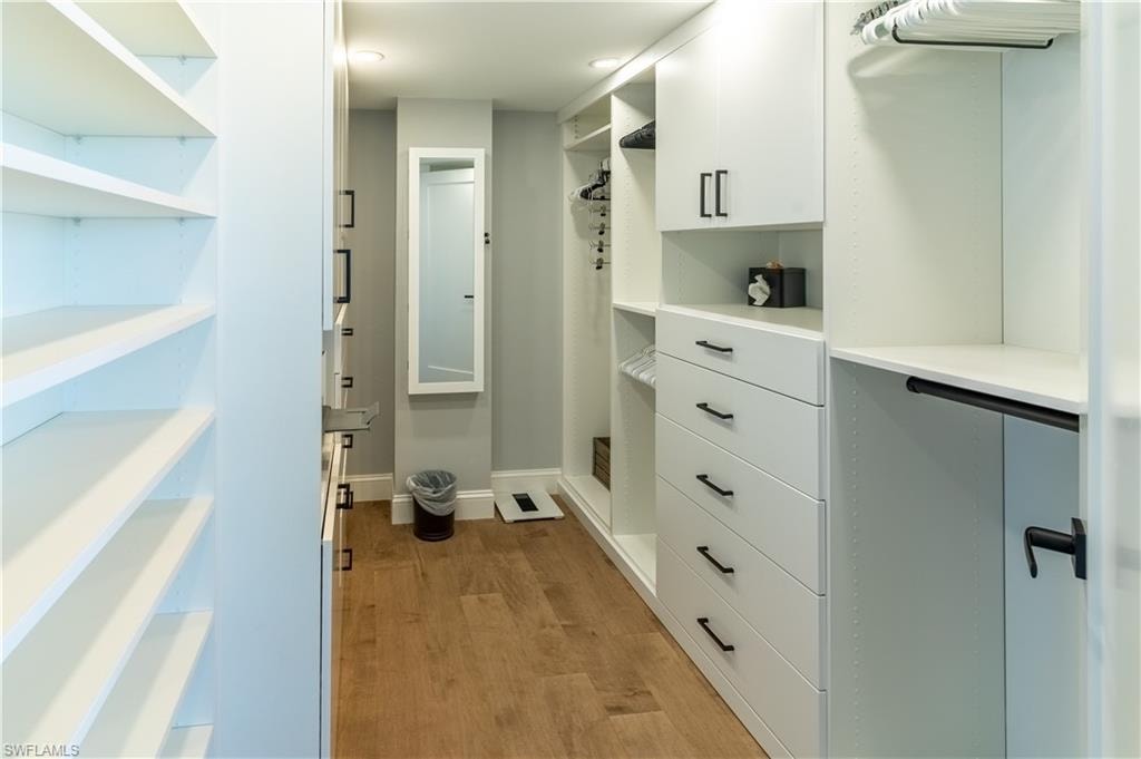 Walk in closet featuring light wood-style flooring