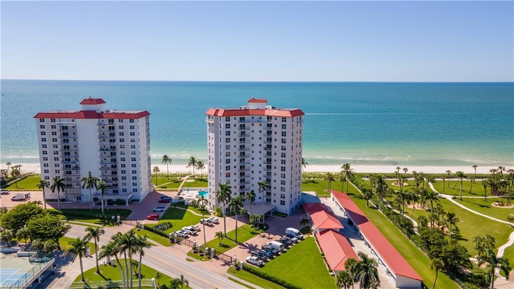 Drone / aerial view of unending shoreline and apartment complex