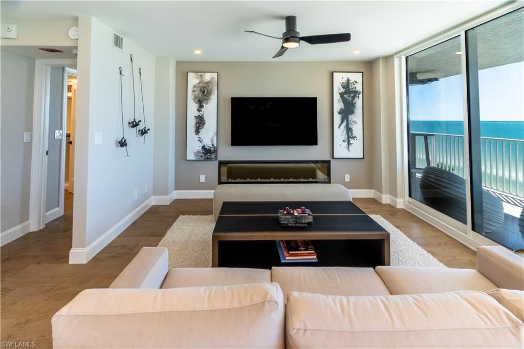 Living room featuring wood finished floors, a ceiling fan, and recessed lighting
