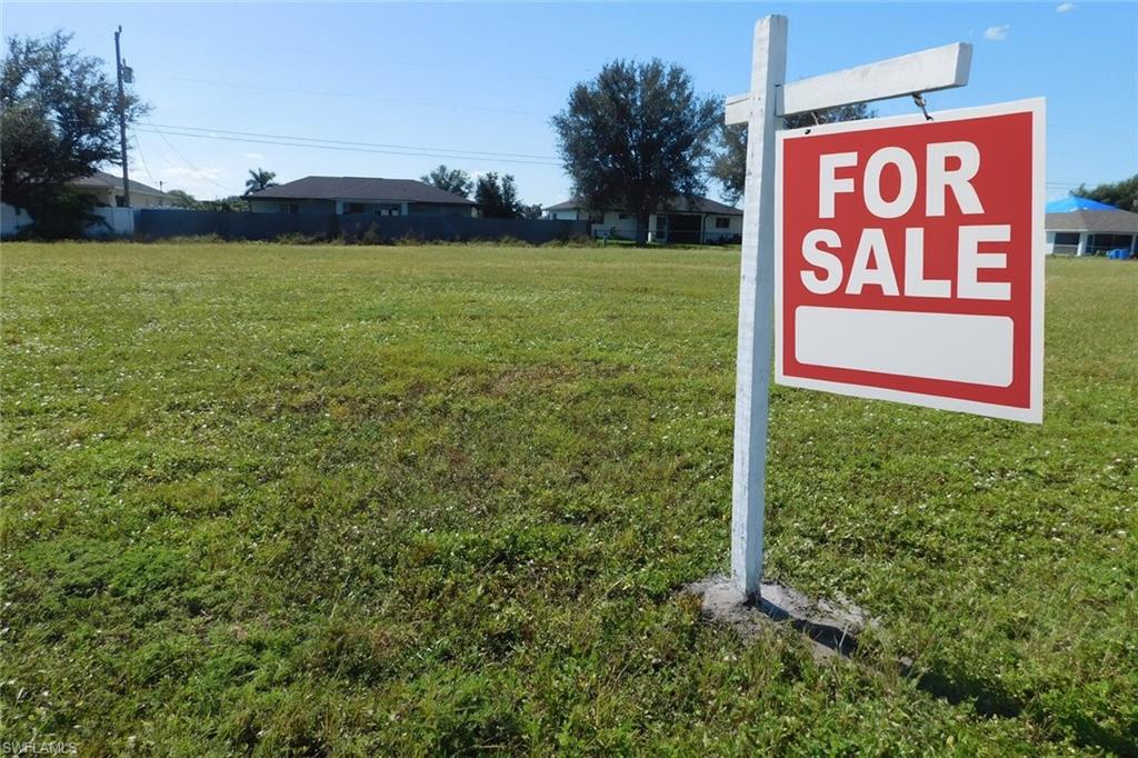 Vacant lot with AI enhancement with "For Sale Sign"