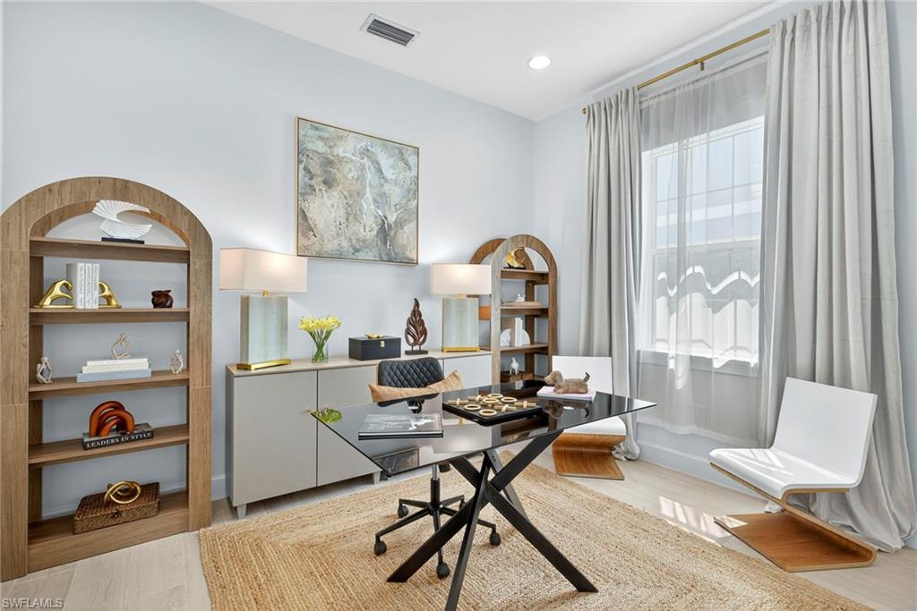 Home office with light wood-type flooring and recessed lighting