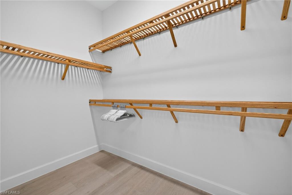Walk in closet featuring light wood-style floors