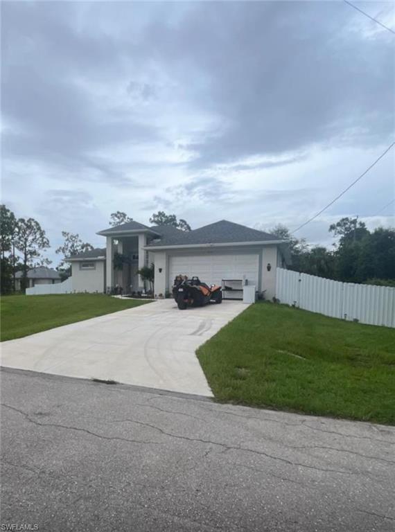 View of front of house with driveway and an attached garage