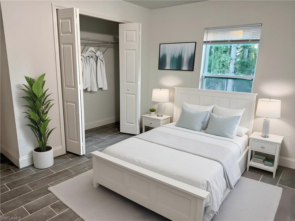 Bedroom featuring wood tiled floors and a closet
