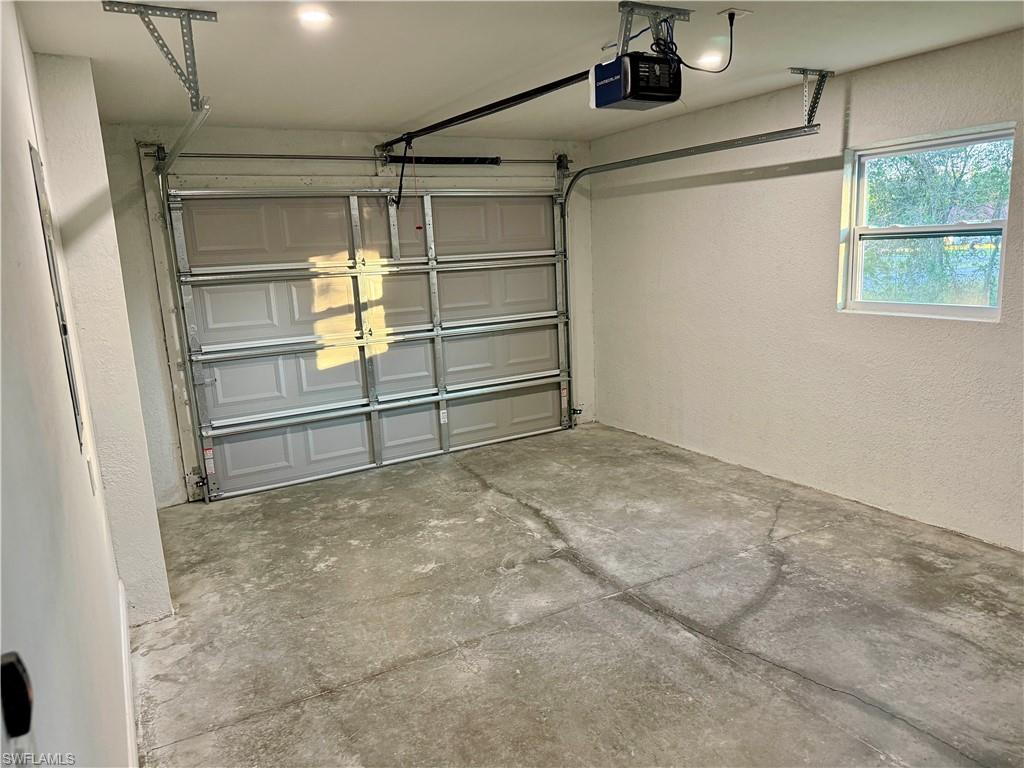 Unfurnished room with baseboards and dark wood-style floors