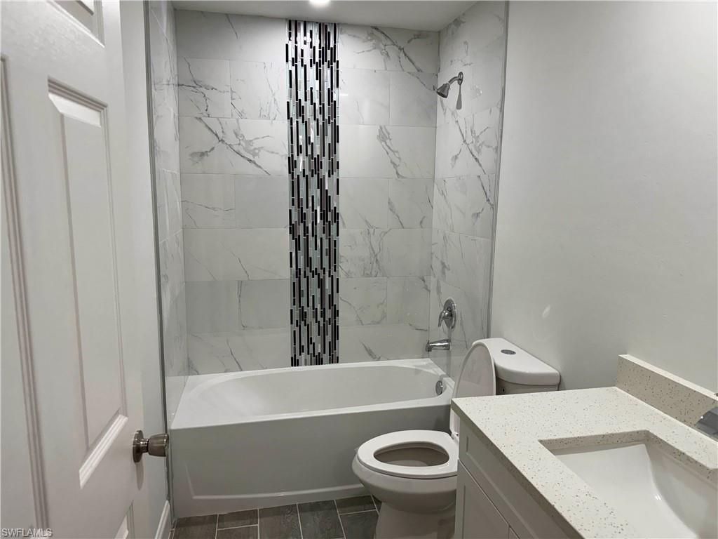 Full bath featuring bathtub / shower combination and vanity