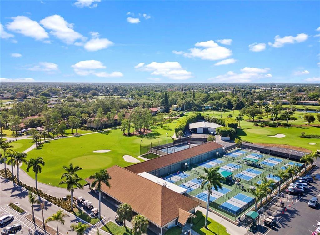 Drone / aerial view of a local golf course and a tree filled landscape