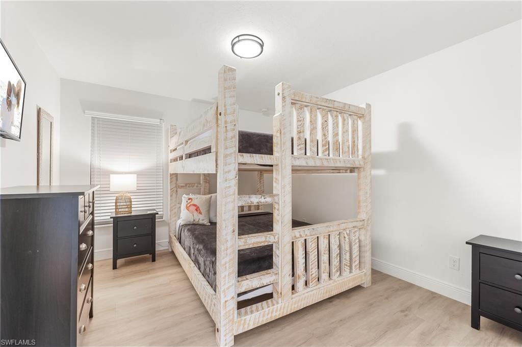 Bedroom with light wood-style flooring and baseboards