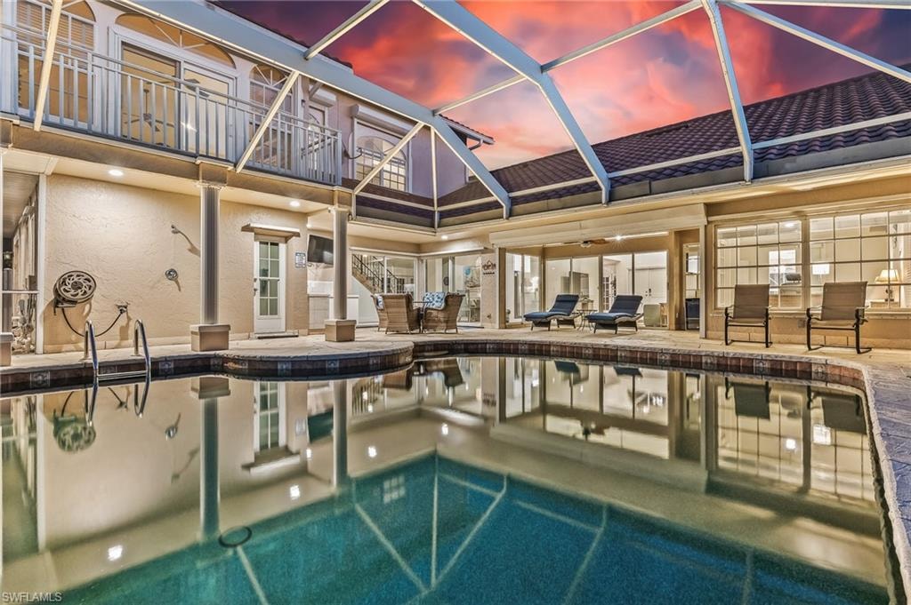 Indoor community pool featuring a sunroom