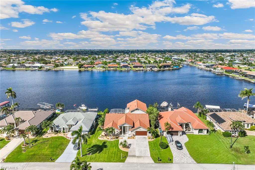Aerial perspective of suburban area featuring a large body of water