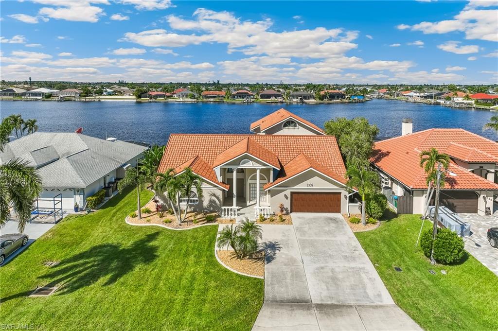 Aerial view of residential area featuring a nearby body of water