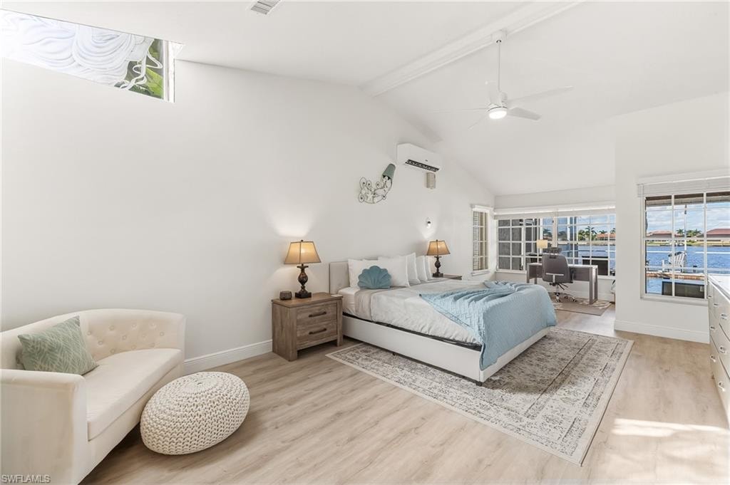 Bedroom with beamed ceiling, light wood-type flooring, high vaulted ceiling, and a ceiling fan