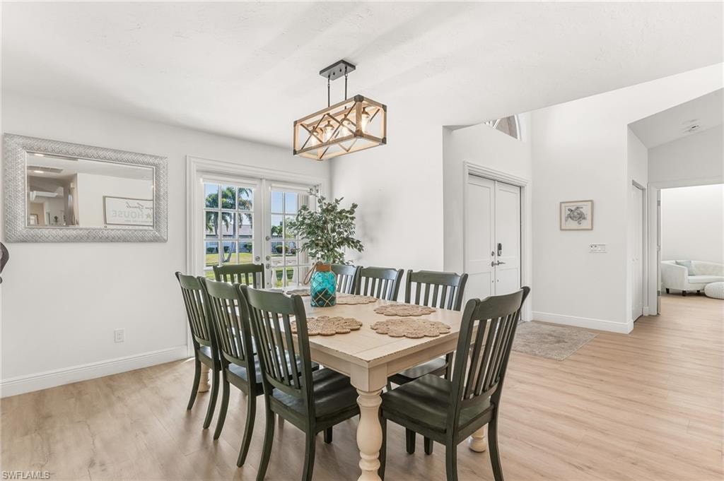 Dining room featuring light wood-type flooring and french doors