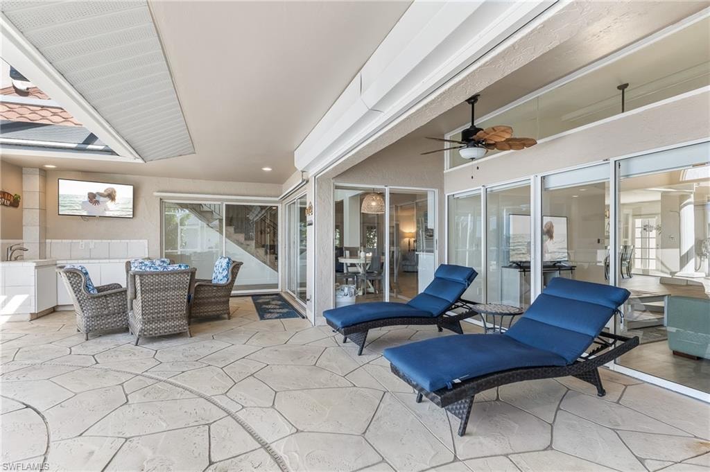 View of patio featuring a ceiling fan and outdoor dining space