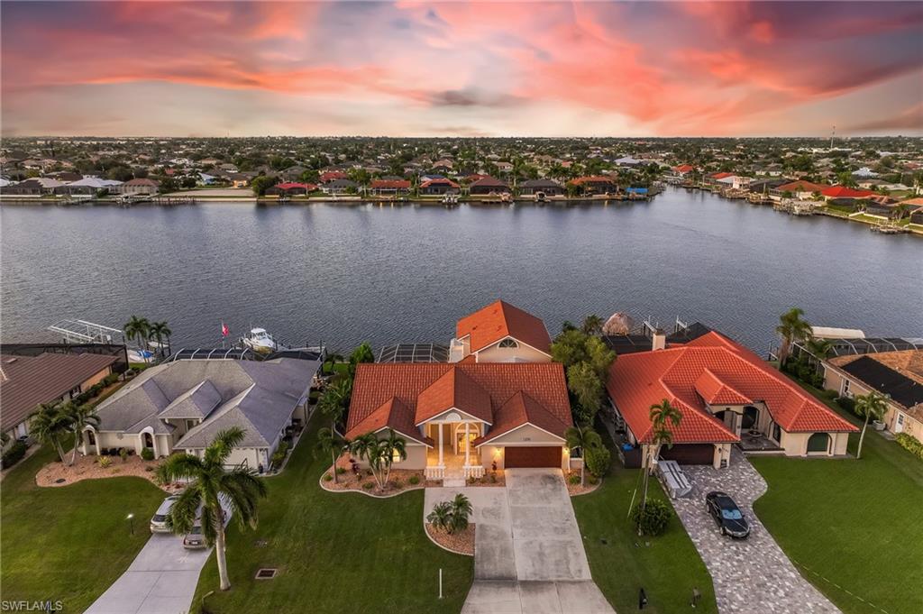 Aerial view of residential area featuring a large body of water