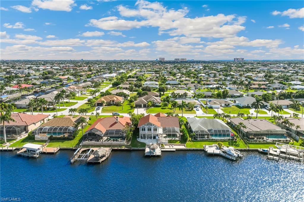 Aerial perspective of suburban area featuring a large body of water
