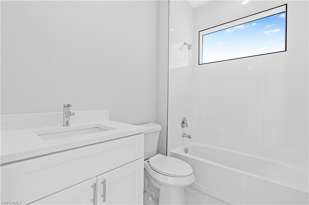 Bathroom featuring vanity and  shower combination